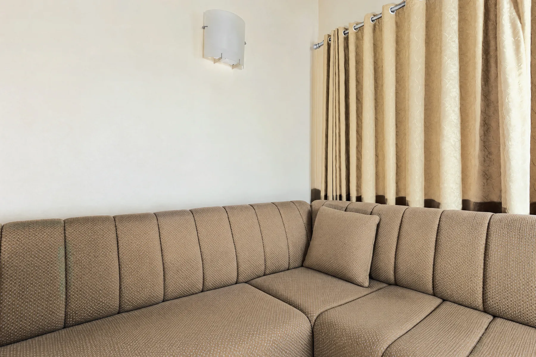 The same lounge as October's AI drew it: neutral daylight and the blanket gone; sofa, lamp and curtains kept.